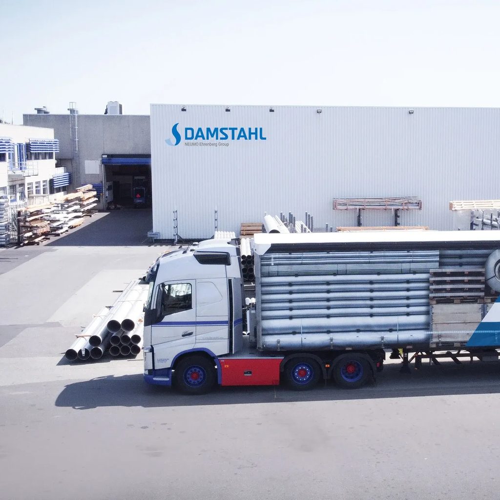 A Damstahl truck loading stainless steel tube outside the warehouse
