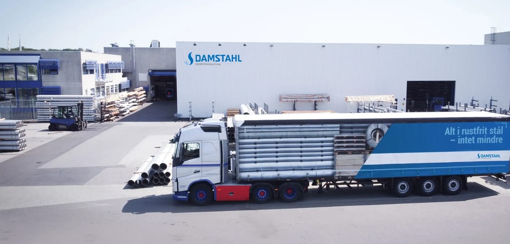 A Damstahl truck loading stainless steel tube outside the warehouse